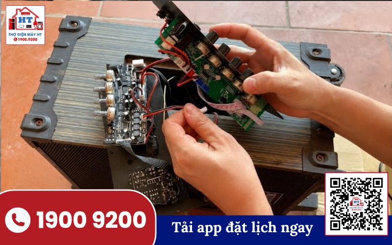 Kỹ thuật viên đang kiểm tra bo mạch bên trong loa kéo để chẩn đoán nguyên nhân mất tiếng